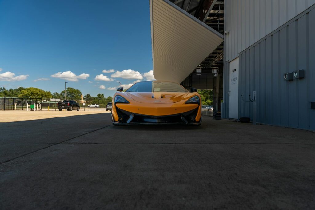 Yellow McLaren supercar parked at an airport hanger in Illinois, USA.
