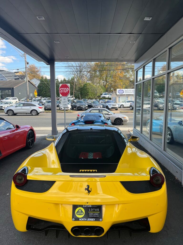 A vibrant yellow Ferrari 458 waits at a New Jersey dealership, ready to impress.