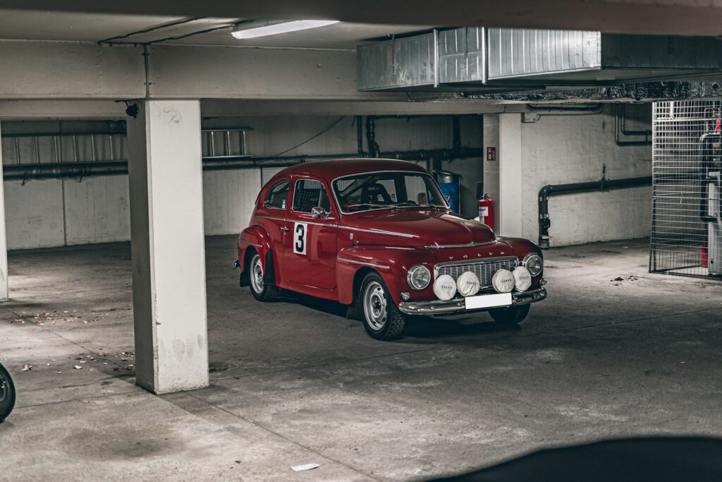 a red car parked in a parking garage