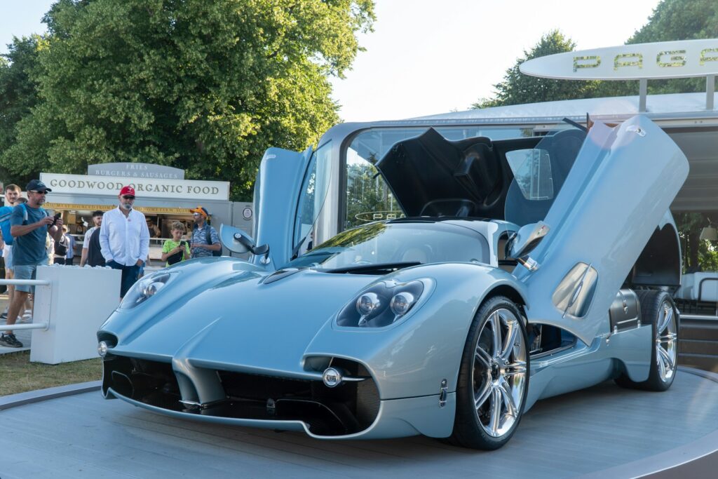 A luxurious blue sports car with doors open.
