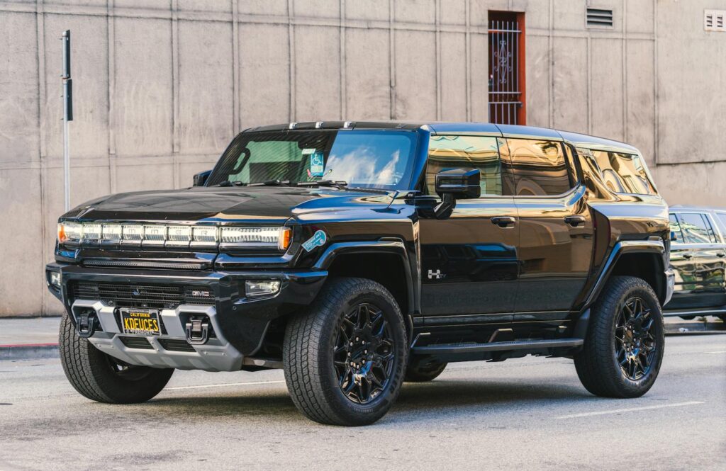 A modern Hummer EV parked on a city street showcasing sleek design and electric power.