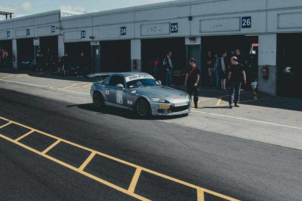 parked coupe beside man