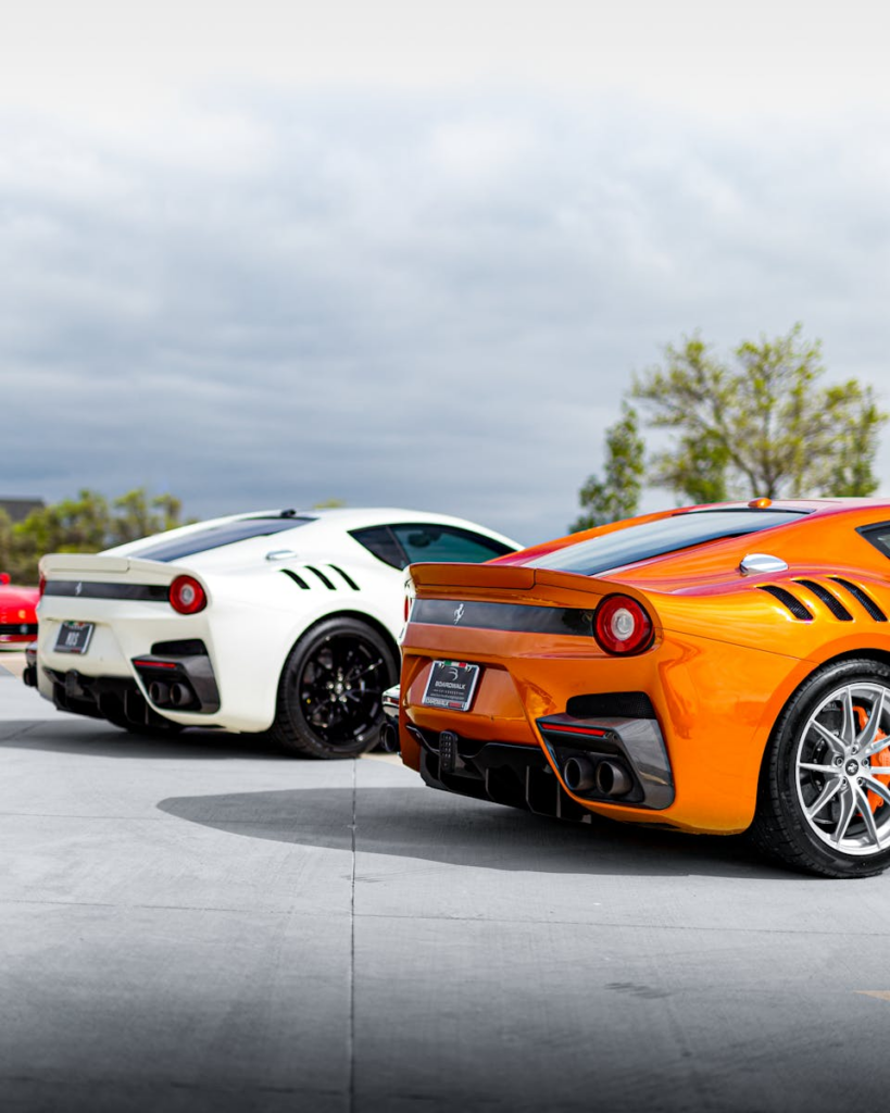 Stunning Ferrari sports cars lined up outdoors showcasing elegant design and vibrant colors.