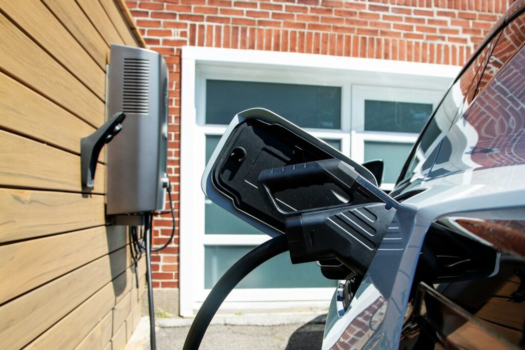 Electric car charging station on a wooden wall