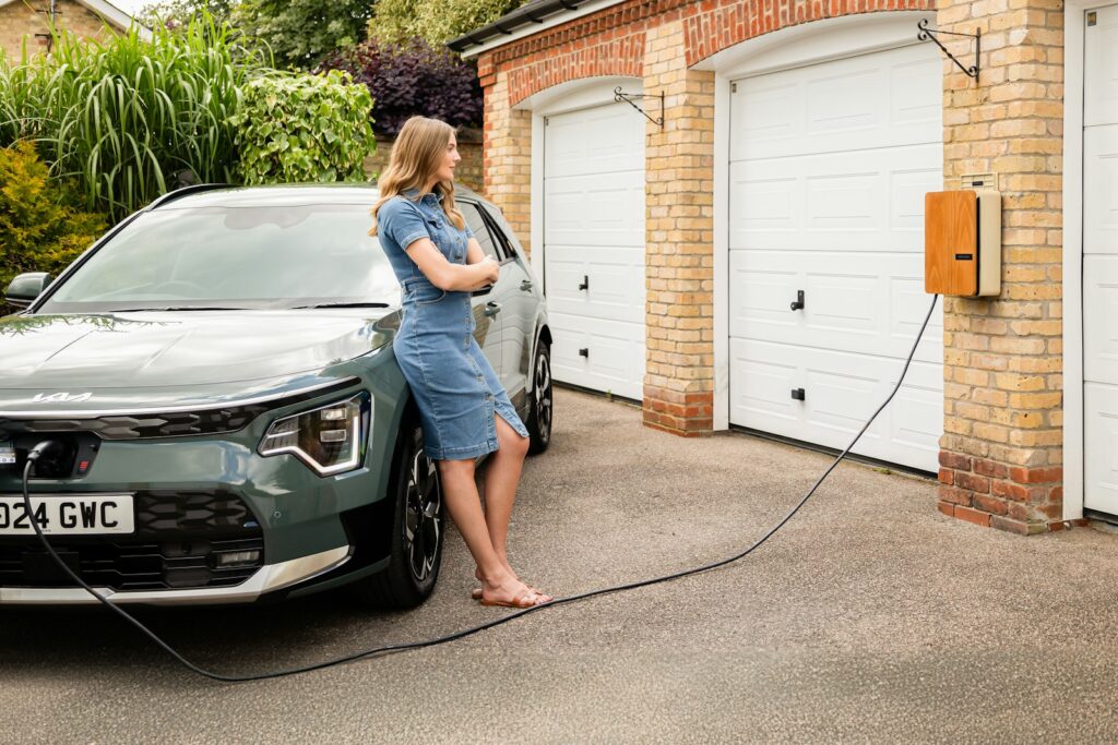 A woman washing a car in a driveway