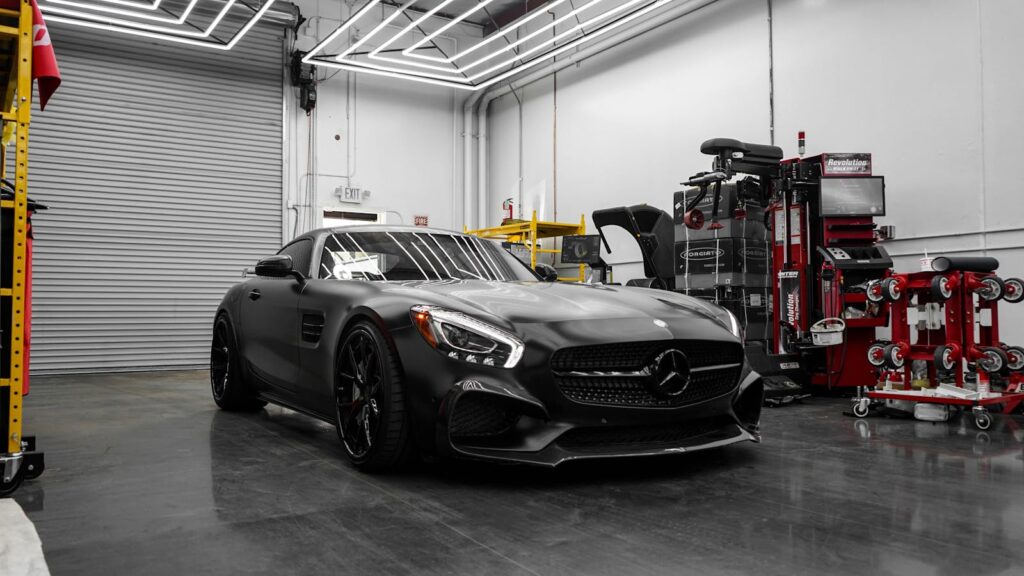 Matte black Mercedes-Benz AMG GT S parked in a stylish garage.
