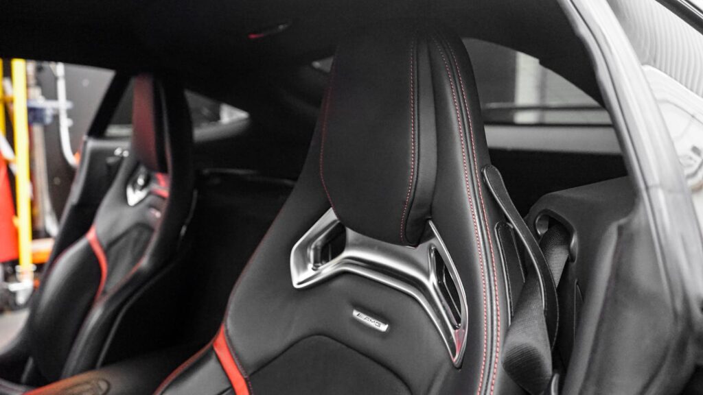 Close-up of a sleek, modern luxury car seat highlighting premium materials and design.