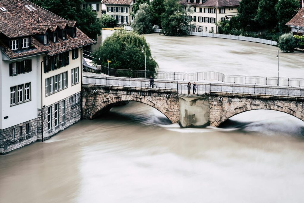Aerial view of a historic bridge over a flooded river in Bern, Switzerland.