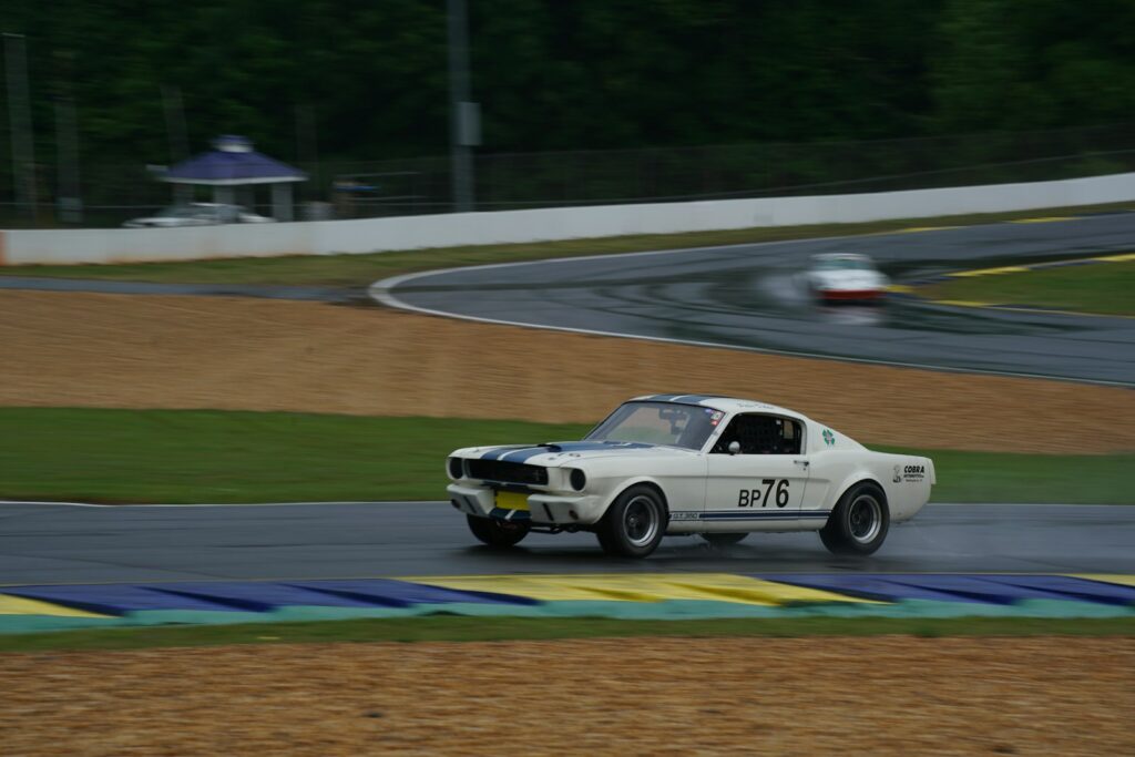 a white car driving down a race track