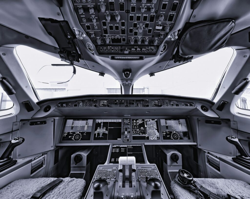 the inside of an airplane with multiple controls