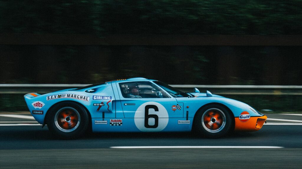 Classic Ford GT40 racing on the highway, showcasing vintage speed.