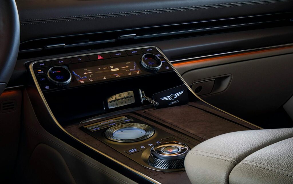 Experience the sophisticated design of a Genesis car interior featuring a sleek gear shift and modern controls.