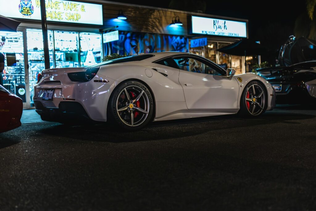 A white sports car parked on the side of the road