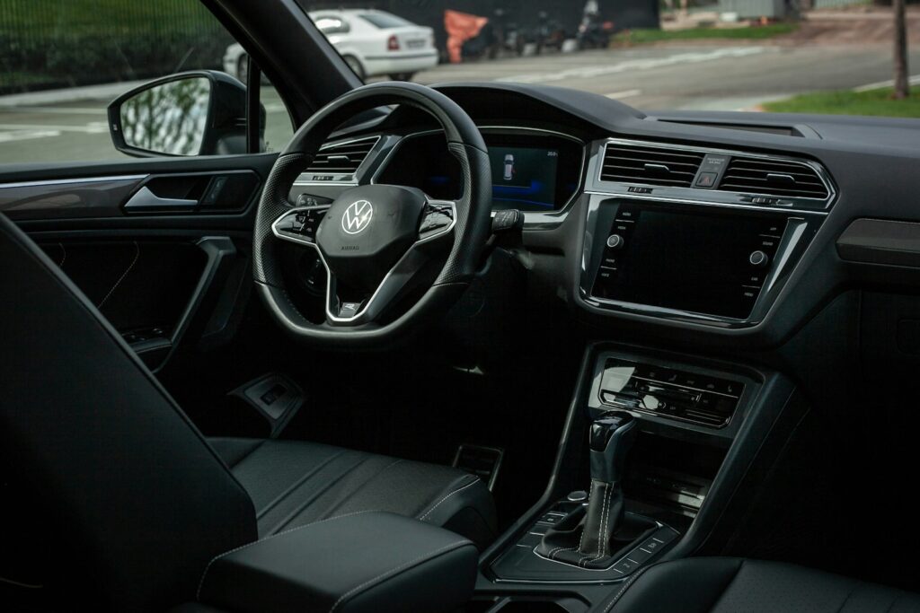 Modern car interior with dashboard and steering wheel.