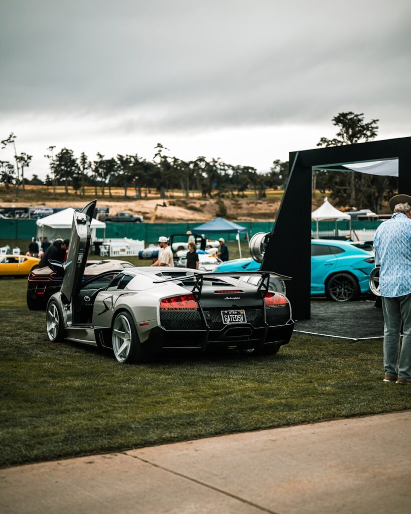 Silver lamborghini with doors open at car show