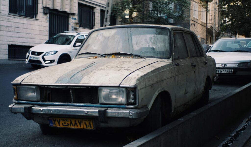 Old car parked on a city street