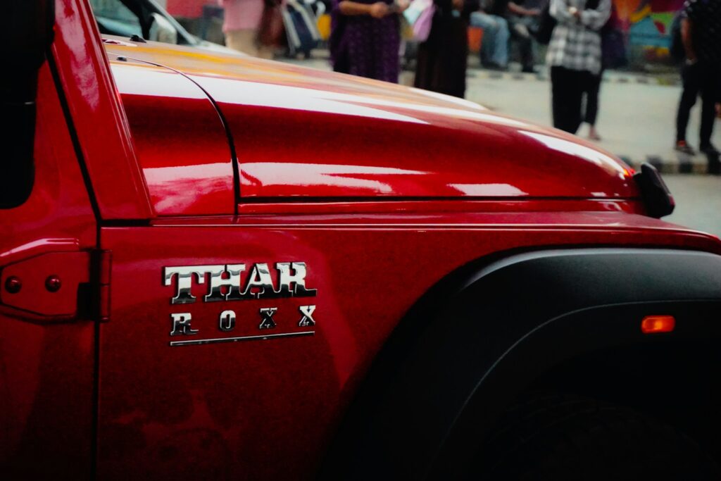 Red car with thar badge on fender
