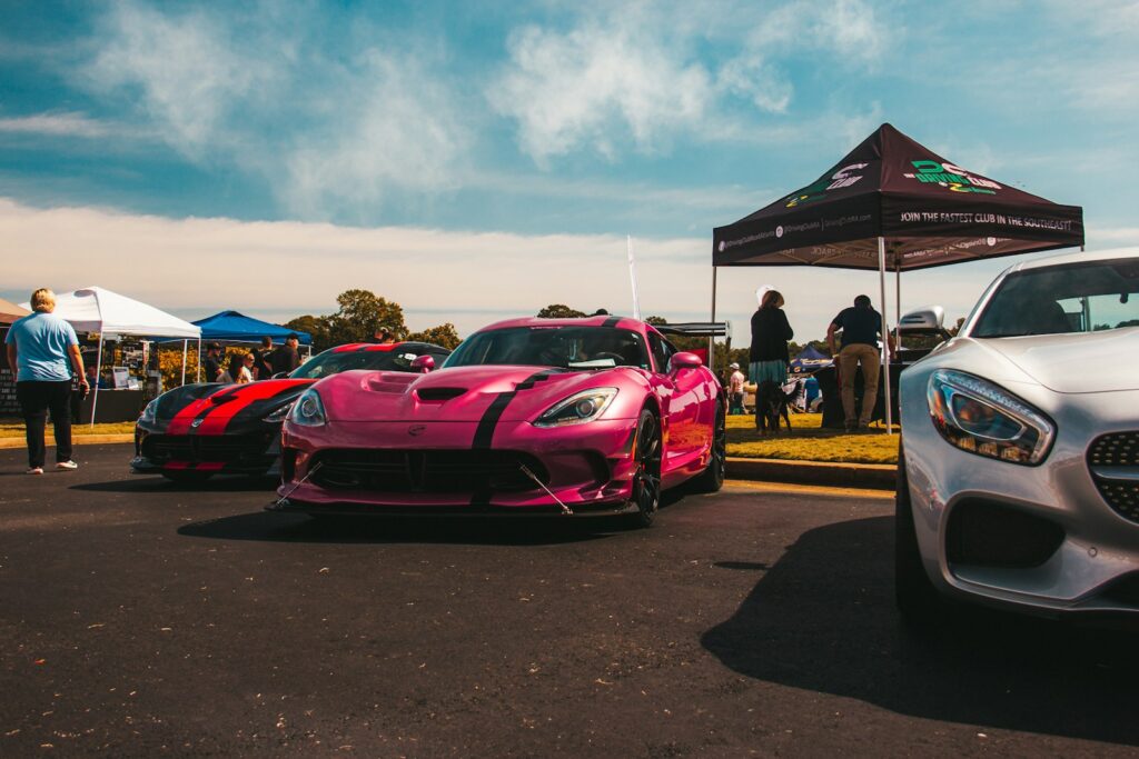 two cars parked next to each other in a parking lot
