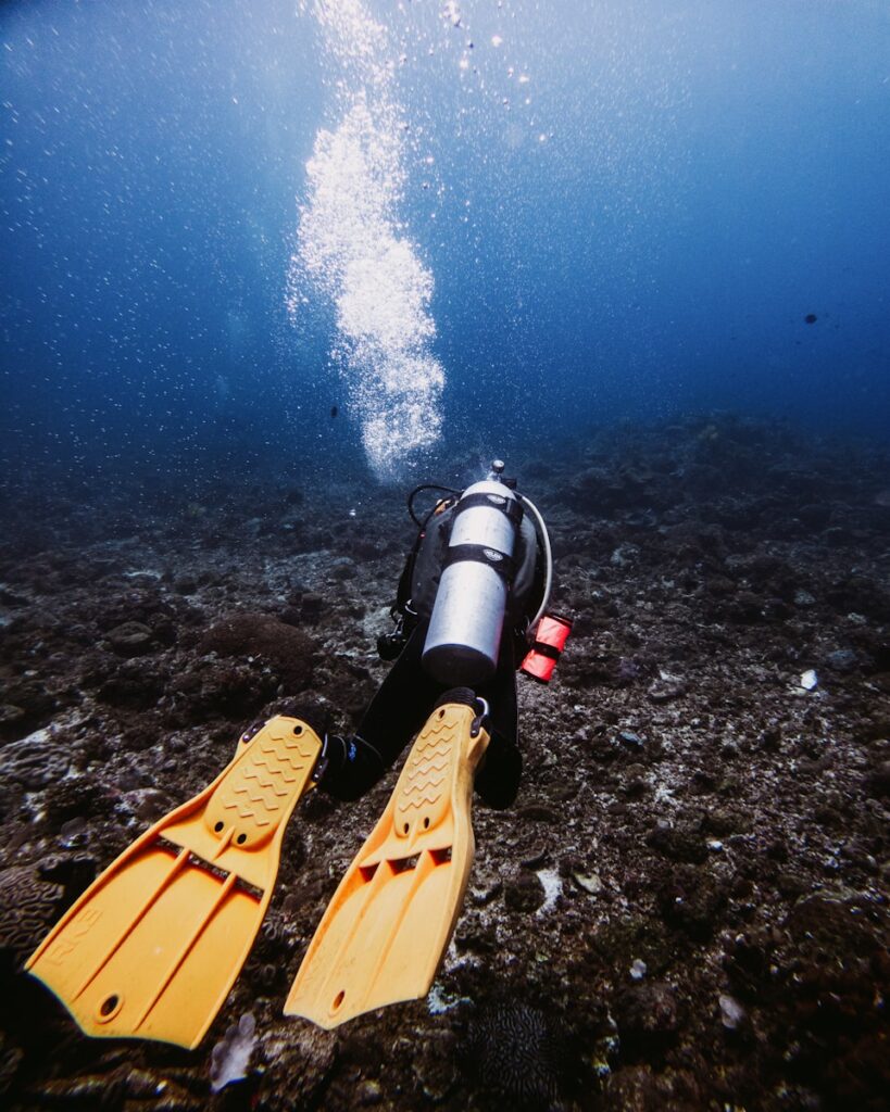 Scuba diver ascending from the ocean floor