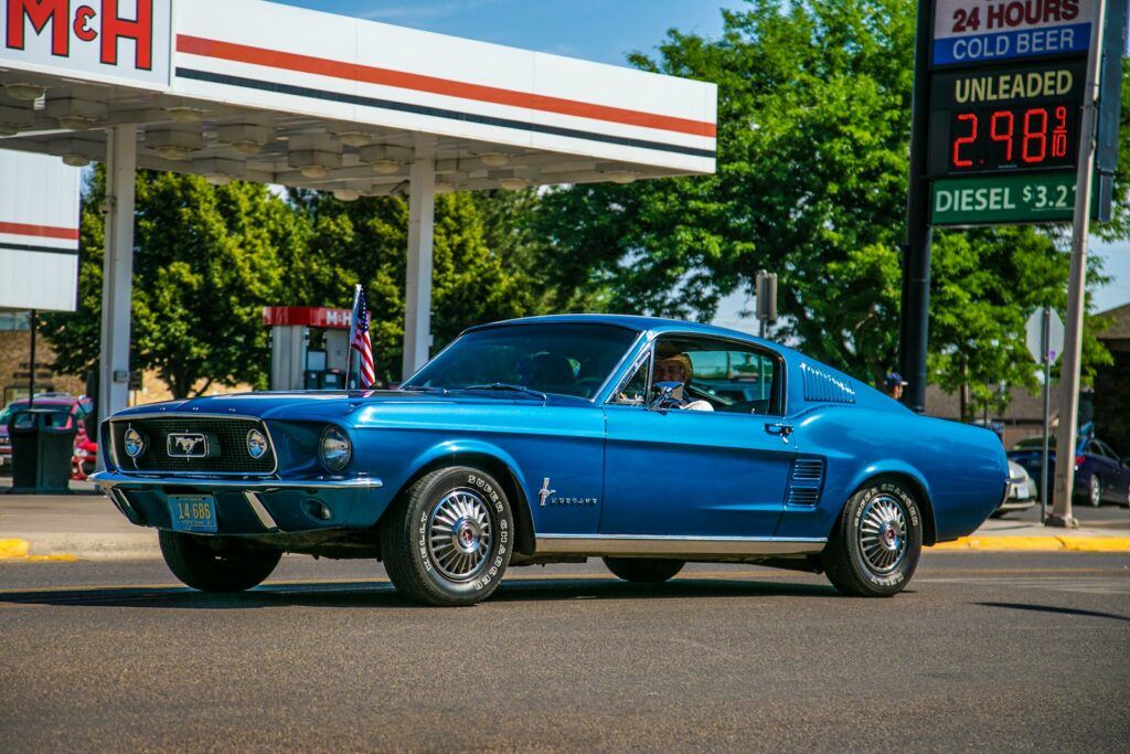 blue chevrolet camaro parked in front of white and red building
