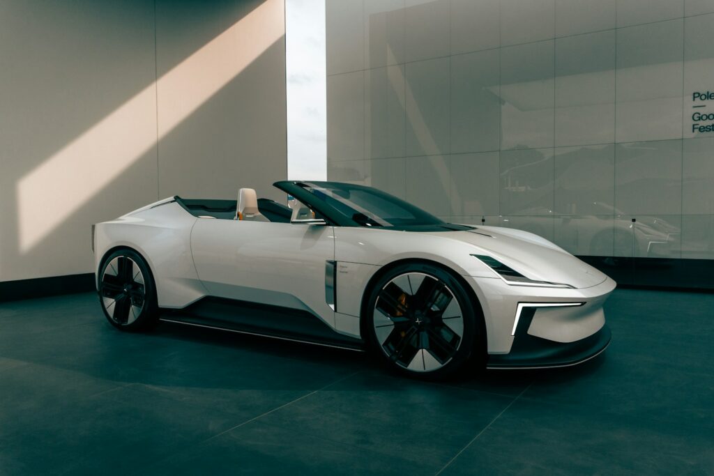 Sleek white convertible sports car in modern showroom.