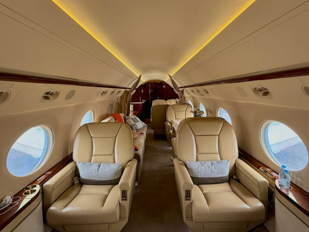 Luxurious interior of a private jet with comfortable seating.