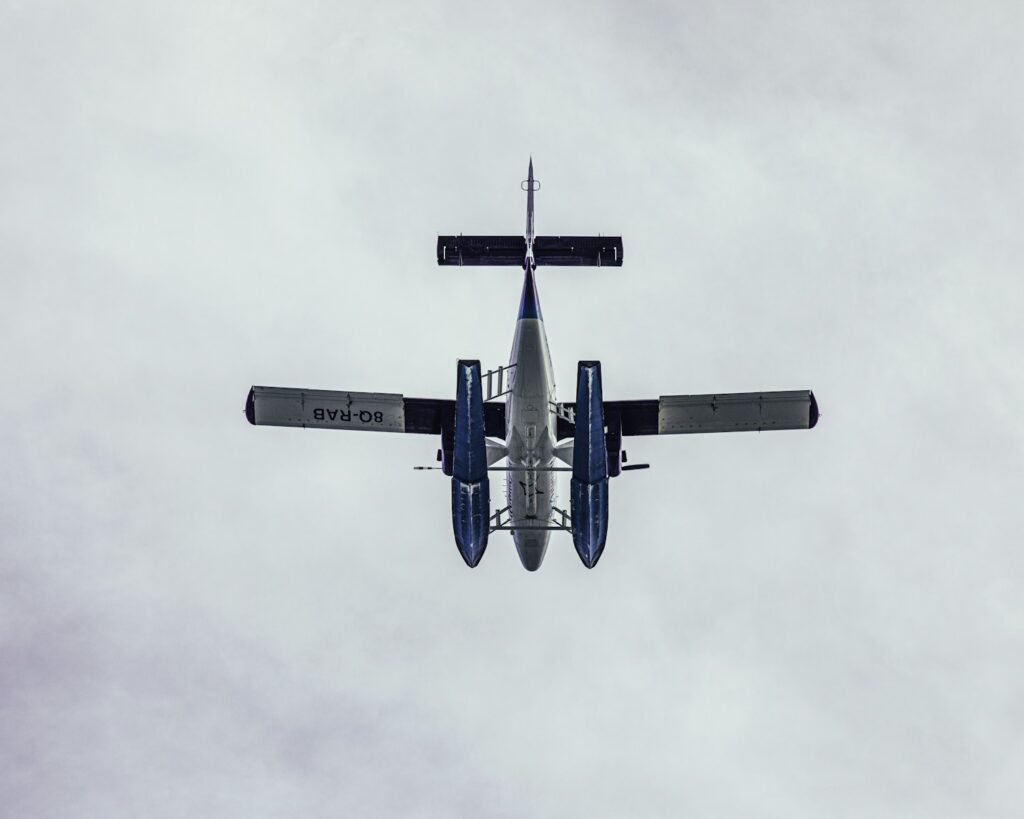 blue and white airplane flying in the sky