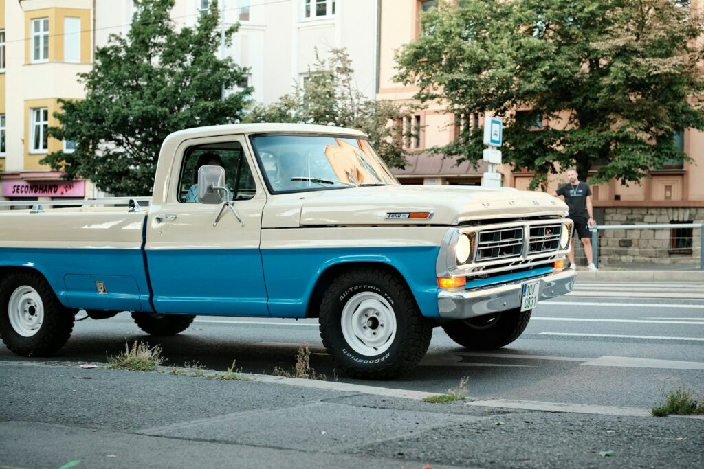 Vintage two-tone pickup truck driving on a street