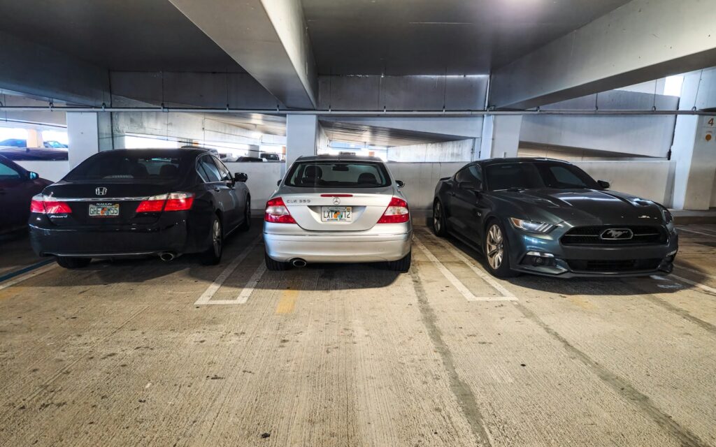 A group of cars parked in a parking garage