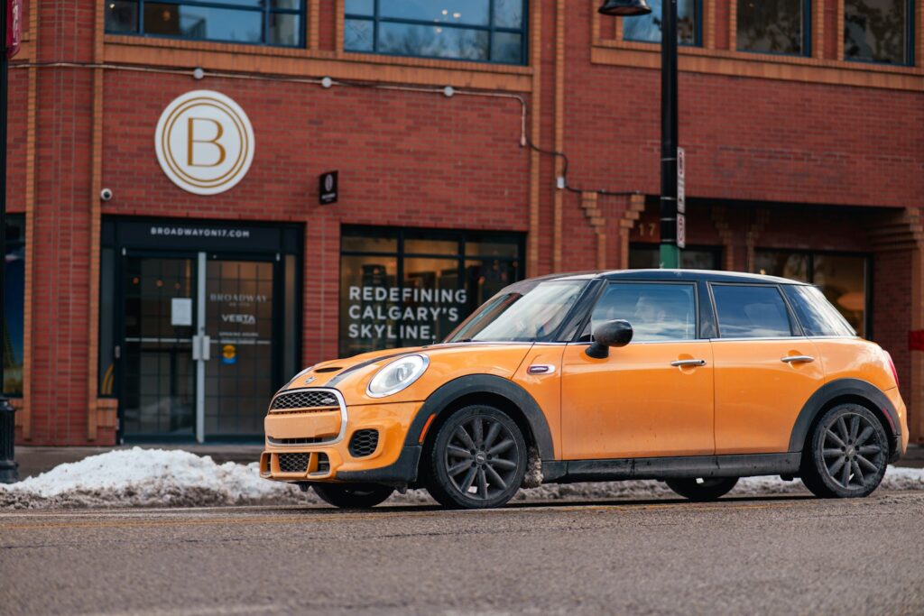 Orange mini cooper parked on city street