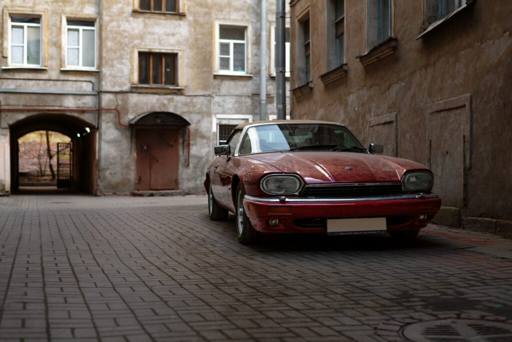 a red car parked on a brick street