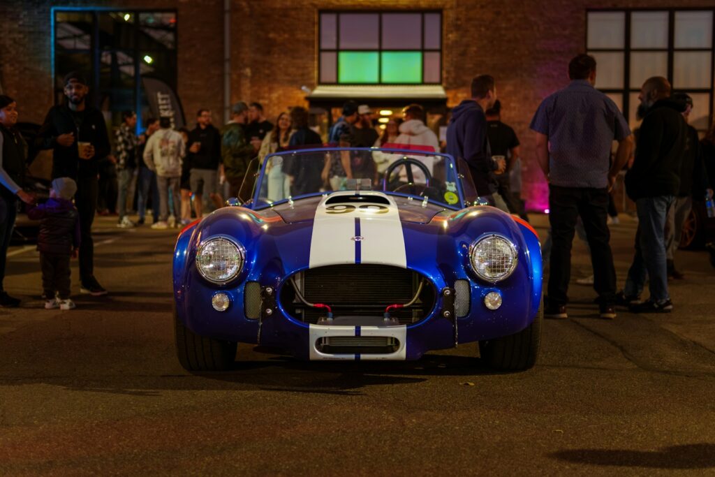 A blue and white car parked in front of a building