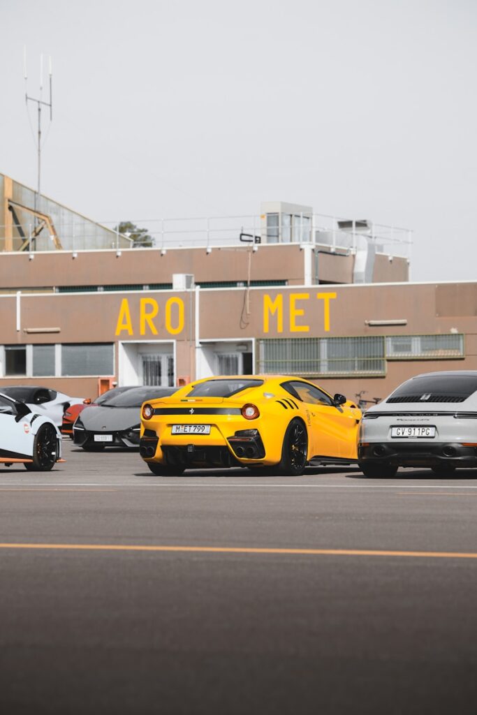 Several luxury sports cars parked outside building