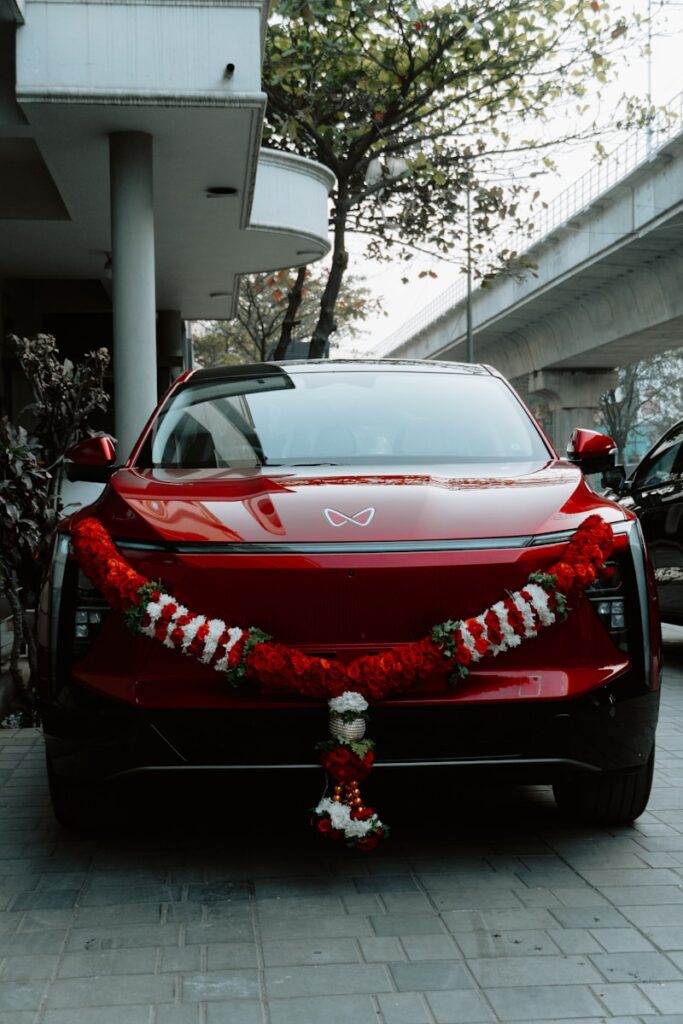Red car decorated with floral garlands