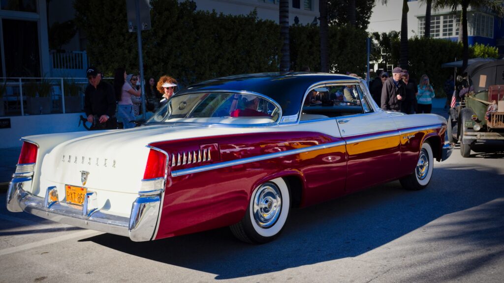 a red and white car parked in a parking lot