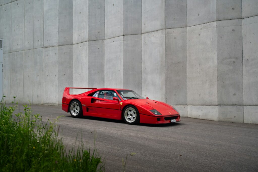 A red sports car parked on the side of a road