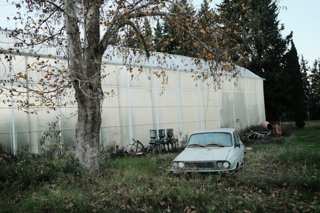 An old car parked in front of a building