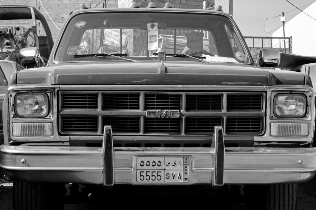 Front view of a classic GMC vehicle in black and white, showcasing vintage design.