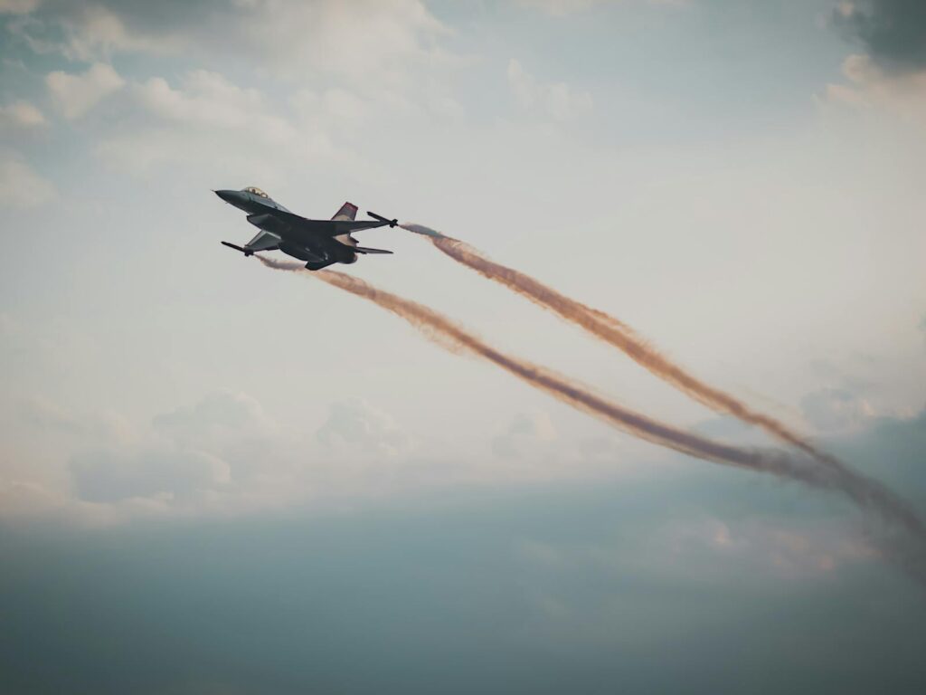 Dynamic capture of a military fighter jet soaring through a cloudy sky.