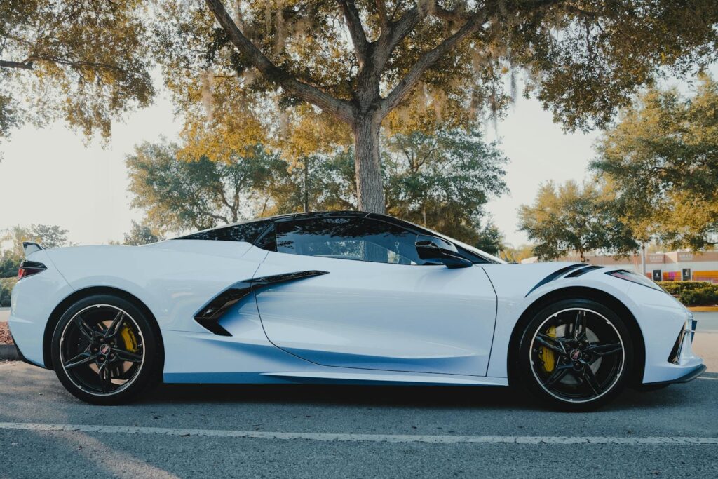 A stunning white C8 Corvette parked outdoors, showcasing its luxury and speed.
