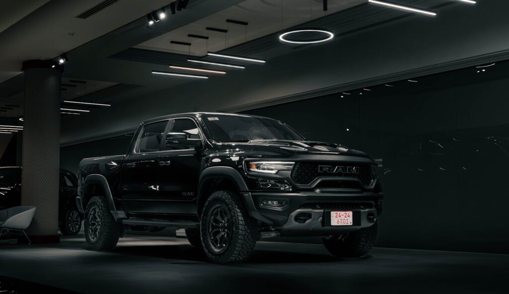 Sleek black pickup truck on display in an elegant indoor showroom setting.