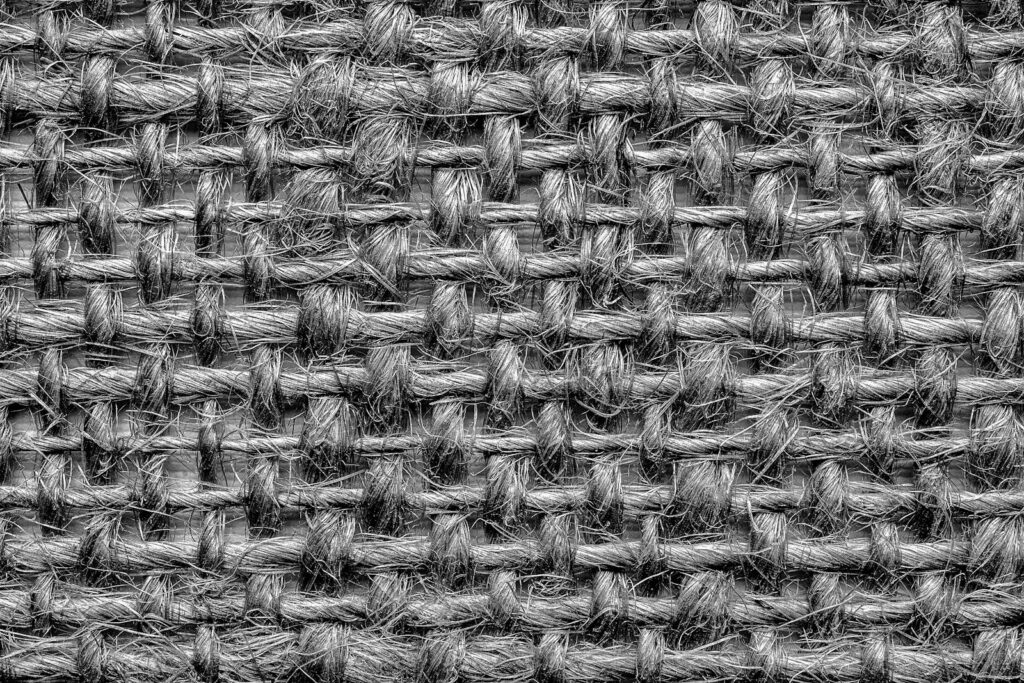 Detailed close-up of woven textile showcasing gray tones and intricate texture.
