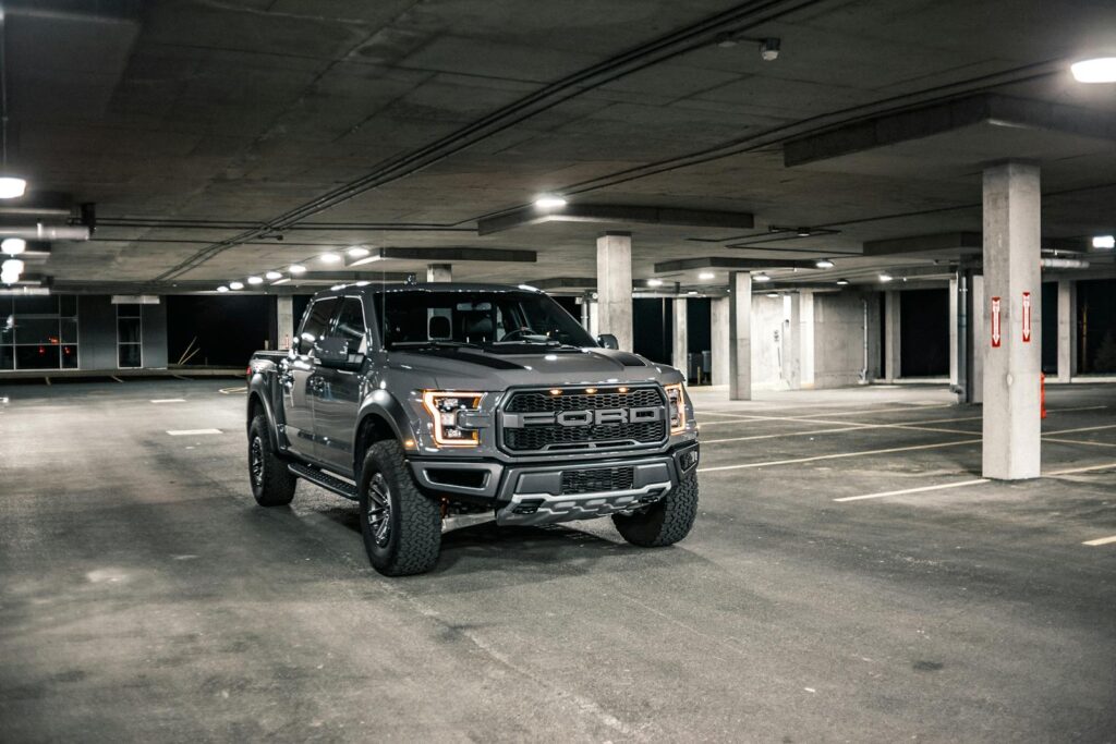 Sleek gray pickup truck parked in a well-lit underground garage, showcasing its modern design.