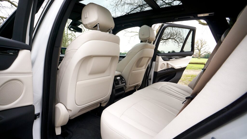 Explore the spacious and luxurious interior of a BMW SUV, featuring leather seats and a sunroof.