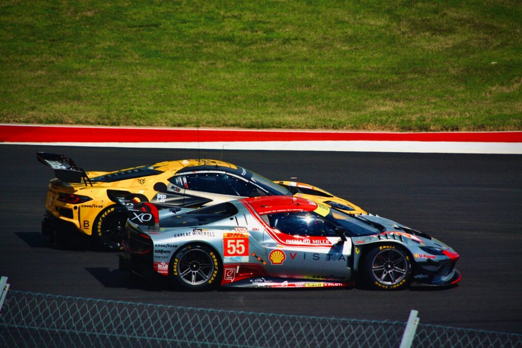 Race cars speed along the track.