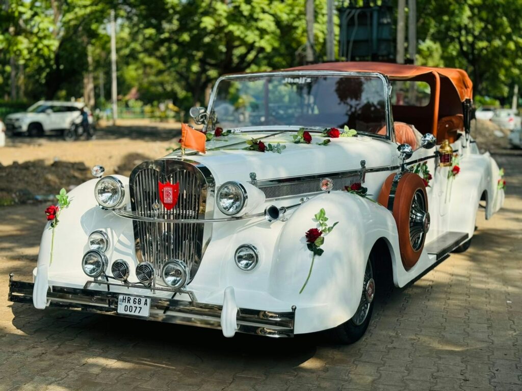 An old fashioned car decorated with flowers and ribbons