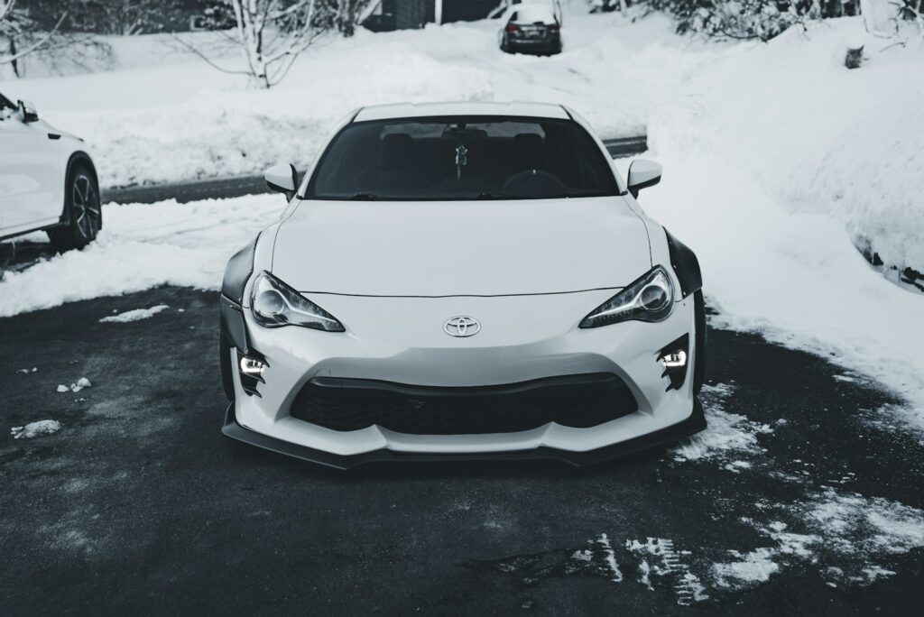 White sports car parked on a snowy driveway