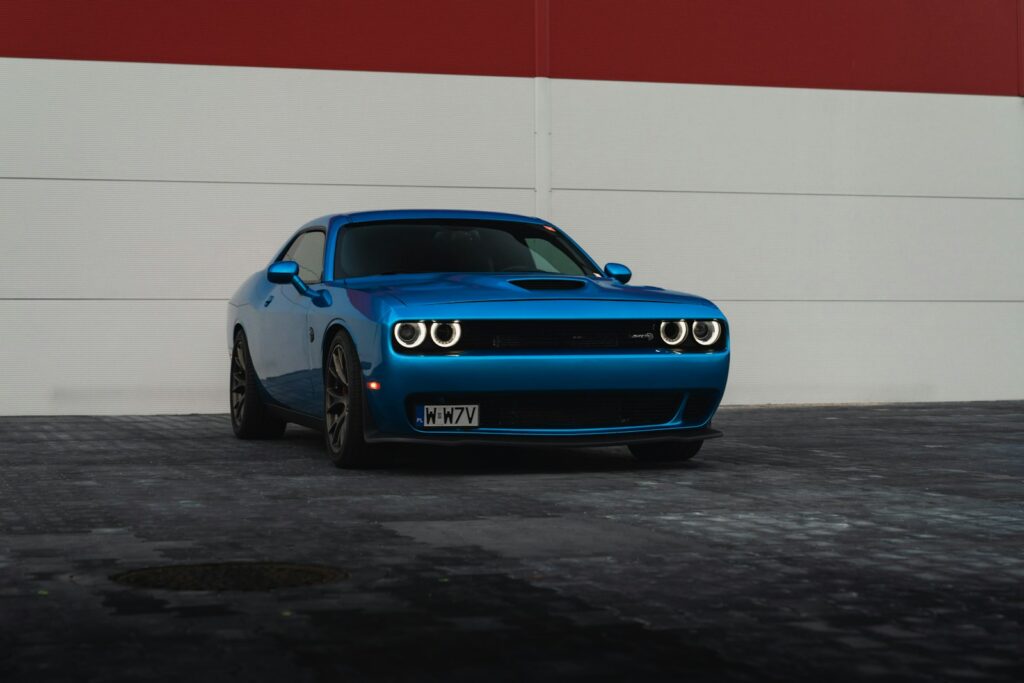 A blue dodge challenger is parked.