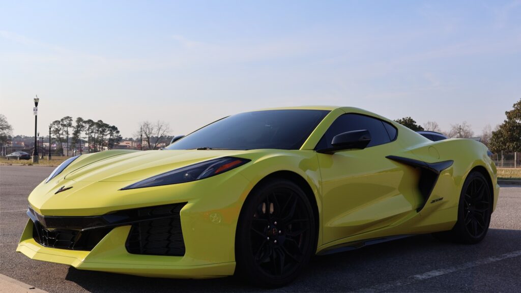 A yellow sports car parked in a parking lot
