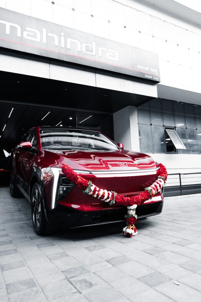 A new red car decorated with a garland